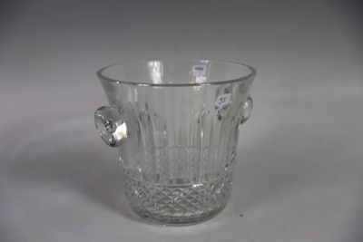 a clear glass vase with a handle on a table