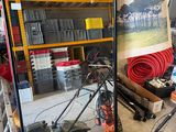 une photo d'un homme en train de réparer une tondeuse à gazon dans un garage