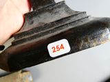 a hand that is holding a metal object with a number on it