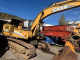 a yellow excavator that is sitting in the dirt