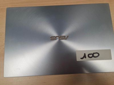 l'arrière d'un ordinateur portable argenté sur lequel est collé un autocollant
