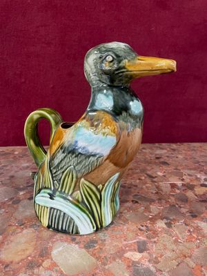 a bird that is sitting on a vase on a table