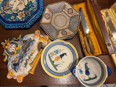 many plates and bowls on a table with a knife and fork