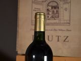 a bottle of wine sitting on a table next to a box