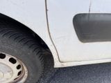 a white truck with a flat tire on the street