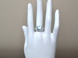 a hand with a ring on it that is sitting on a mannequin
