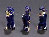 three figurines of men dressed in blue suits and hats on a gray surface