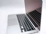 two laptops sitting side by side on a white surface