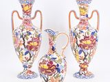 three vases sitting next to each other on a white surface