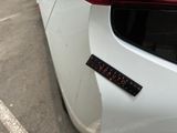 a sticker on the side of a white car