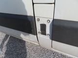 a close up of a door handle on a white van