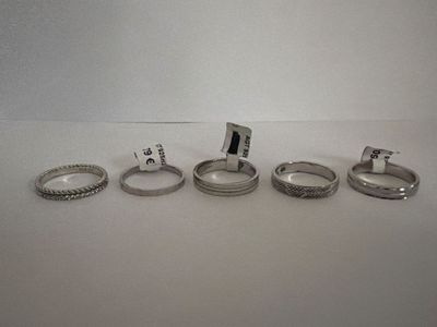 four different types of rings are shown on a white surface