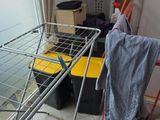 a laundry basket and a drying rack in the corner of a room