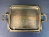 a silver tray with handles and handles on a blue background
