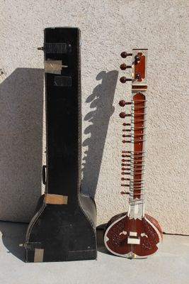 two musical instruments sitting next to each other on the ground