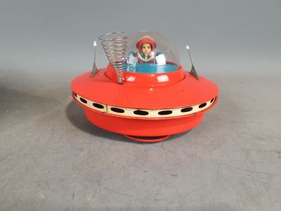 a toy that is sitting on top of a red object