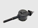 a small black object that is sitting on a white surface