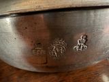 a metal bowl with a lid on a wooden table