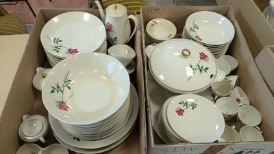 a lot of dishes and cups in a box