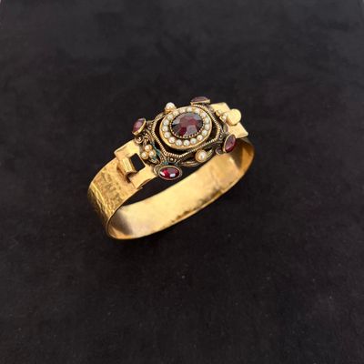 a close up of a gold ring on a black surface
