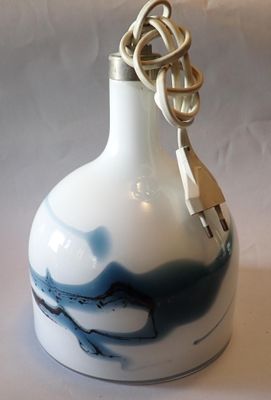 a white and blue vase with a knot on it