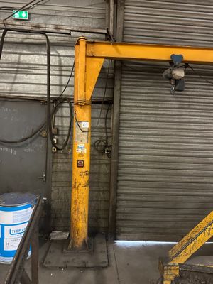 a yellow crane that is sitting in a garage