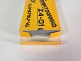 a yellow box with a razor on it on a white surface