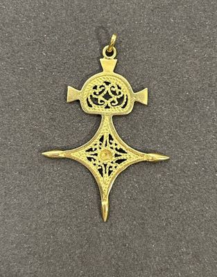une croix en or surmontée d'une couronne