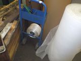 a cart with a roll of paper next to a cart with a roll of paper on it