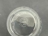 a small glass jar with a lid on a table