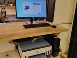 a desk with a computer and a printer on it