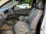 the interior of a car with the door open and the driver ' s seat down