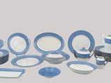 blue and white dinnerware set on a table with a gray background