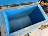 a blue cooler that is sitting on the ground