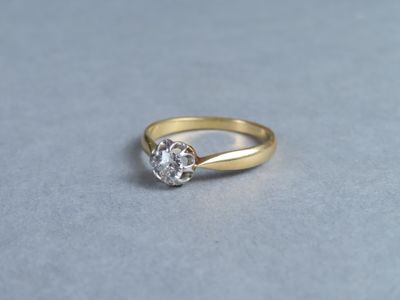a close up of a gold ring with a diamond on it