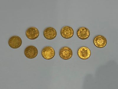 a close up of a group of gold coins on a white surface