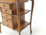 a small wooden table with three drawers on top of it