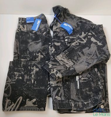 a pair of black and white jeans with a blue tag on them