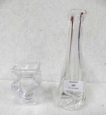 a glass vase and a glass candle holder on a table