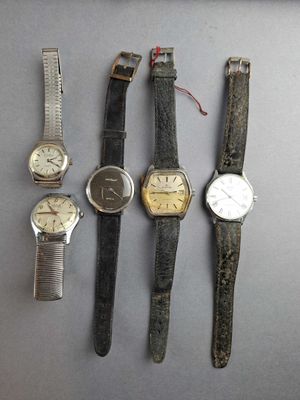 several different types of watches sitting on top of a table