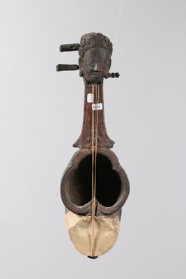 a sculpture of a violin that is hanging on a wall