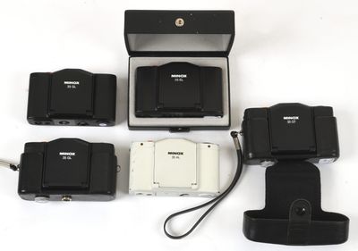 four cameras that are sitting next to each other on a table