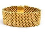 a close up of a gold bracelet on a white background