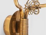 brass plated wall sconce with flowers and wire wrapped around it