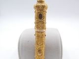 a close up of a gold ring on top of a white ring