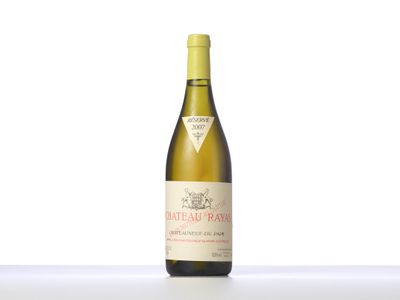 the bottle of white wine is sitting on the table
