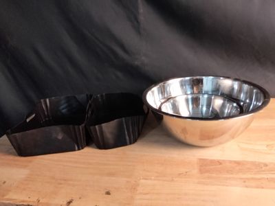 un saladier en métal posé sur une table en bois