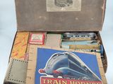 a box full of train items on a table