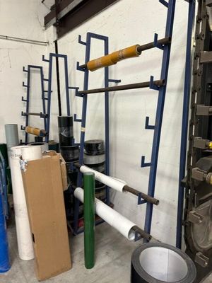 a room with a ladder and a bunch of rolls of paper in it