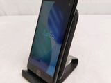 the phone is sitting on the stand on the table